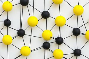 Network of interconnected yellow and black spheres photo