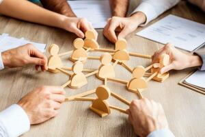 Collaborative team building. Hands connect wooden figures in a network structure photo