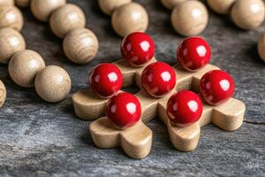 Wooden game pieces with red balls photo