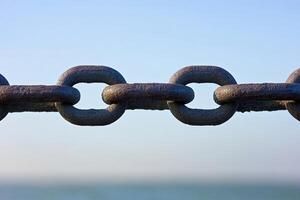 Rusty Chain Against a Sky photo