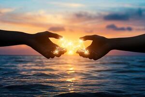 Two hands connecting, illuminated by golden light photo