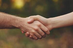 Close-up of a handshake in a natural setting photo