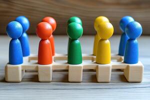 Colorful figurines arranged on a wooden stand photo