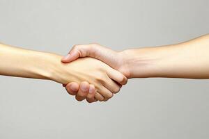 Two people shaking hands over a gray background photo