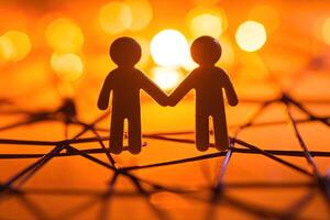 Two figures holding hands, a symbol of connection and love photo