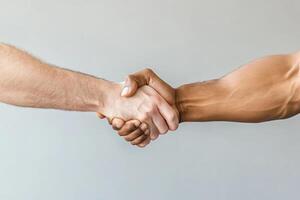 Two men shaking hands over a gray background photo