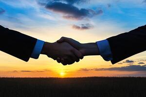 Business handshake at sunset photo