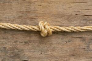 A tied rope on wooden planks photo