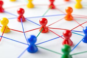 Colorful figurines interconnected by threads, forming a network photo