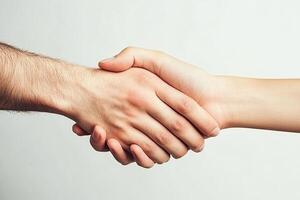 A man and woman shaking hands over a white background photo