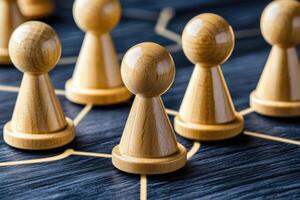 Wooden figures connected by network lines photo
