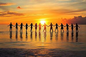 Silhouettes of people linked hands at sunset photo