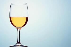 A glass of pale yellow wine photo
