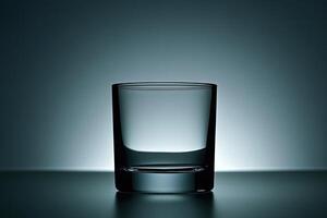 Empty shot glass on a dark surface photo
