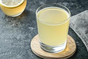 Refreshing lemon drink in a glass photo