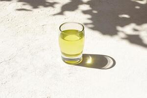 Pale yellow liquid in a shot glass photo
