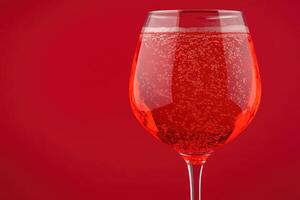 Sparkling red drink in a glass photo