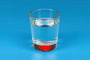 Clear liquid in a shot glass photo