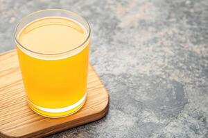 Fresh, vibrant juice in a glass photo