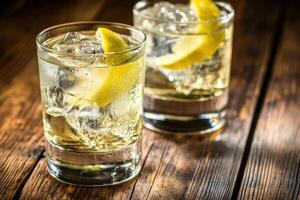 Two refreshing cocktails garnished with lemon slices photo
