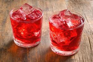 Two chilled ruby red drinks with ice cubes photo
