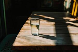 Glass of water on wooden table photo