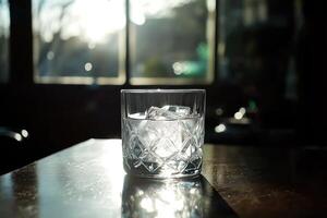 A glass of iced water on a table photo