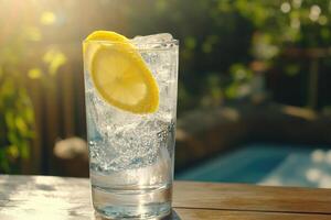 A glass of water with lemon on top photo