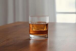 Single amber liquid drink with ice cube photo
