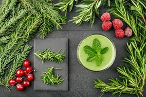 Fresh green smoothie with winter herbs photo