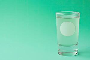 Clear shot glass filled with liquid, blank label photo