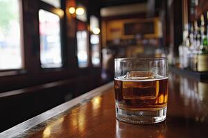 Whiskey in a glass on a bar photo