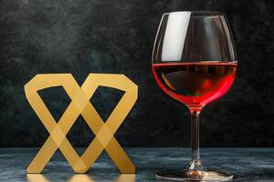 A glass of wine and a gold sign with a wine glass photo