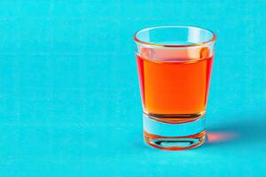 Orange liquid in shot glass photo