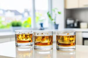 Three whiskey glasses filled with ice photo