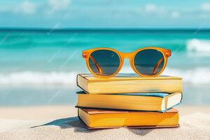 Books and sunglasses on the beach photo