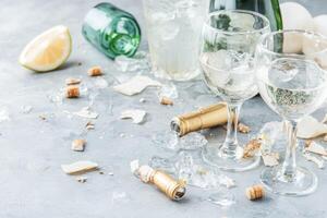 Champagne party aftermath. Broken glasses, corks, and ice litter the surface photo