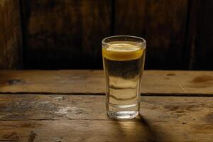Shot of spirit with lemon slice photo