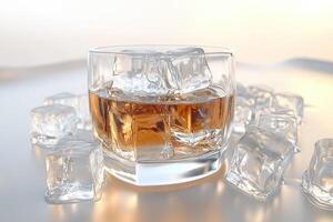 Glass of whiskey with ice cubes photo