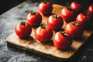 Fresh tomatoes on a wooden cutting board photo