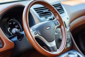Interior of a car with leather steering wheel photo