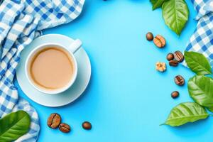 Coffee Cup with coffee beans, leaves, and nuts on a blue surface photo