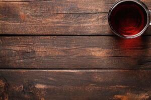 Wooden table with a cup of tea photo