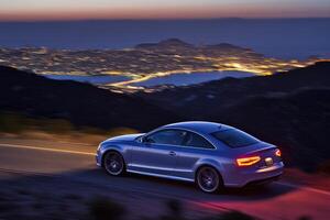 Sporty car on mountain road at twilight photo