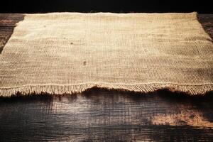 Rustic burlap tablecloth on wooden table photo