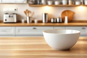 Empty white bowl on a light brown wooden countertop in a blurred kitchen background photo