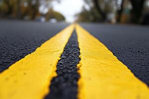 Yellow dividing lines on a paved road photo