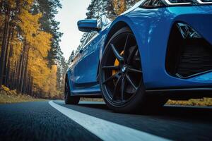 Fast blue car on autumn road photo