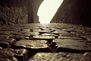Cobbled alleyway leads to light photo