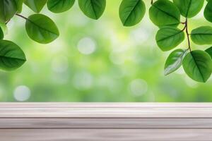 Empty light wooden table with green leaves and bokeh photo